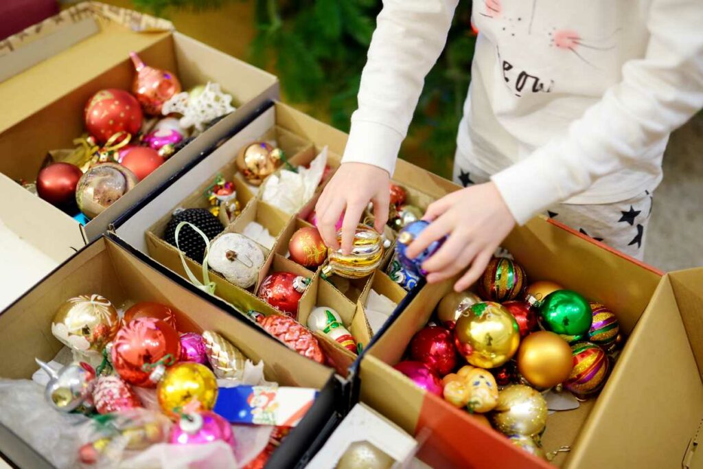 A bunch of colorful ornaments kept in a tidy ornament storage box.