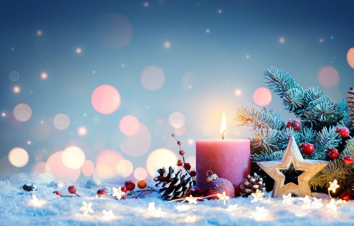 Close-up shot of various seasonal winter decorations on a light surface of snow.